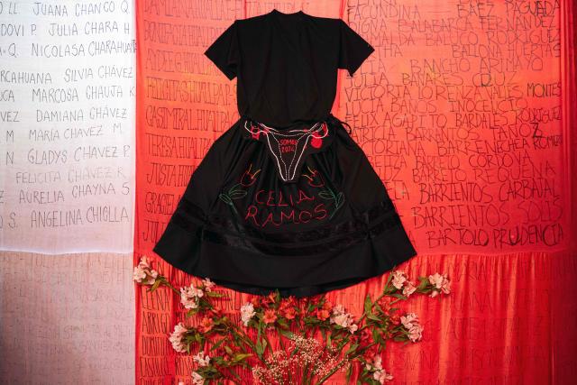 A dress bearing the name of Celia Ramos, a woman who was victim of a forced sterilization, is seen during a performance at the DEMUS Reproductive Rights Center in Lima on March 6, 2026. The daughters of a peasant woman who died in 1997 from a forced sterilization in Peru emphasized that the Inter-American Court of Human Rights "did justice" after the ruling that recognizes the responsibility of the authorities for a practice that affected some 300,000 women in the decade of the 1990s. (Photo by Ernesto BENAVIDES / AFP)