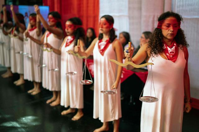 jMarisela (L) and Marcia Monzon, daughters of Celia Ramos, a woman who was victim of a forced sterilization, are seen during a performance at the DEMUS Reproductive Rights Center during a press conference in Lima on March 6, 2026. The daughters of a peasant woman who died in 1997 from a forced sterilization in Peru emphasized that the Inter-American Court of Human Rights "did justice" after the ruling that recognizes the responsibility of the authorities for a practice that affected some 300,000 women in the decade of the 1990s. (Photo by Ernesto BENAVIDES / AFP)