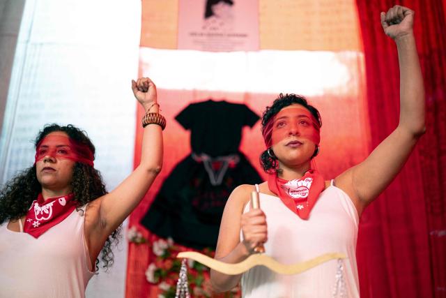 jMarisela (L) and Marcia Monzon, daughters of Celia Ramos, a woman who was victim of a forced sterilization, are seen during a performance at the DEMUS Reproductive Rights Center during a press conference in Lima on March 6, 2026. The daughters of a peasant woman who died in 1997 from a forced sterilization in Peru emphasized that the Inter-American Court of Human Rights "did justice" after the ruling that recognizes the responsibility of the authorities for a practice that affected some 300,000 women in the decade of the 1990s. (Photo by Ernesto BENAVIDES / AFP)