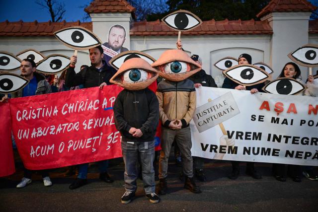 Protesters wearing eye-masks gather in front of the Cotroceni Palace, the headquarters of the Romanian Presidency, during a demonstration called "We see you" against new proposals for the leadership of major prosecutor's offices in Bucharest March 6, 2025. Organized in response to candidates put forward by the Ministry of Justice, demonstrators called for judicial independence and transparency in the appointment process of the prosecutors. (Photo by Daniel MIHAILESCU / AFP)