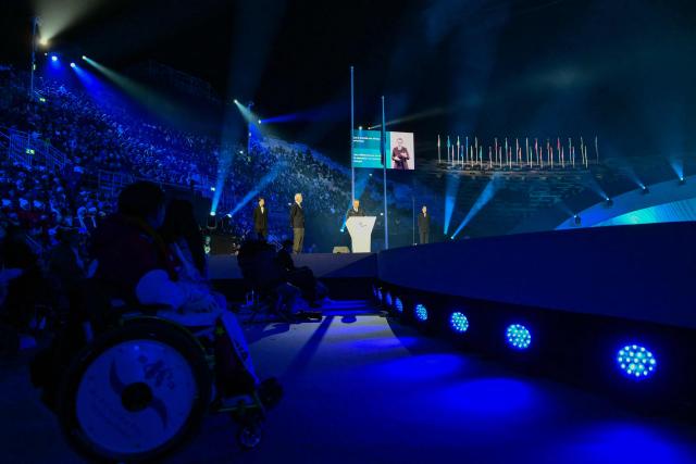 International Paralympic Committee President Andrew Parsons (C) delivers a speech during the Milano Cortina 2026 Winter Paralympic Games opening ceremony at Arena di Verona in Verona on March 6, 2026. (Photo by Stefano RELLANDINI / AFP)