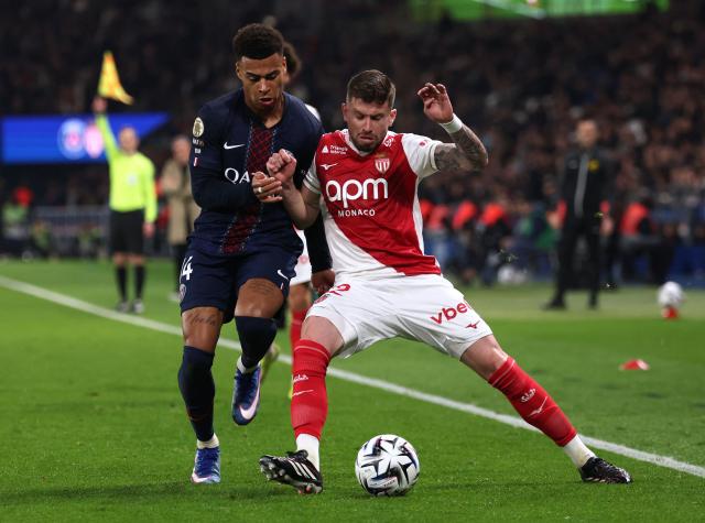 Paris Saint-Germain's French midfielder #14 Desire Doue (L) fights for the ball with Monaco's Brazilian midfielder #12 Caio Henrique  during the French L1 football match between Paris Saint-Germain (PSG) and AS Monaco at the Parc des Princes stadium in Paris on March 6, 2026. (Photo by FRANCK FIFE / AFP)
