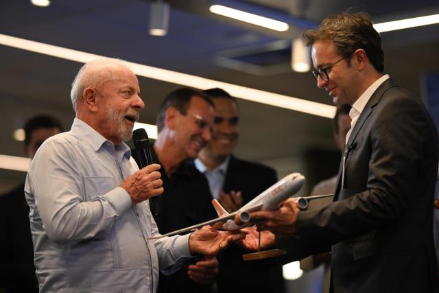 Brazil’s President Luiz Inacio Lula da Silva receives a scale model of a GOL Airlines plane from GOL President and CEO Celso Ferrer Junior (R) during the inauguration of the airport hub at Galeao–Antonio Carlos Jobim International Airport in Rio de Janeiro, Brazil, on March 6, 2026. (Photo by Mauro PIMENTEL / AFP)