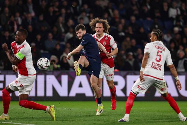 Paris Saint-Germain's Georgian forward #07 Khvicha Kvaratskhelia (L) kicks the ball in front of Monaco's Belgian defender #25 Wout Faes during the French L1 football match between Paris Saint-Germain (PSG) and AS Monaco at the Parc des Princes stadium in Paris on March 6, 2026. (Photo by FRANCK FIFE / AFP)