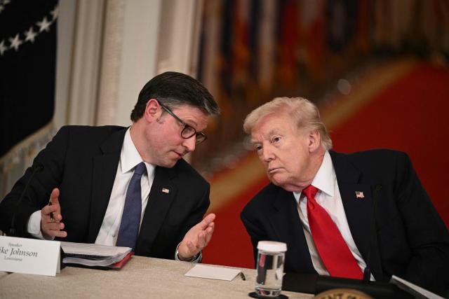 US Speaker of the House Mike Johnson and US President Donald Trump speak during a roundtable to "save college sports" in the East Room of the White House in Washington, DC, on March 6, 2026. (Photo by Brendan SMIALOWSKI / AFP)