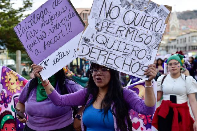 A young women hold signs during a march against government on the eve of International Women's Day in La Paz on March 6, 2026. The International Women's Rights Day will fall on March 8, 2026. (Photo by Jorge BERNAL / AFP)