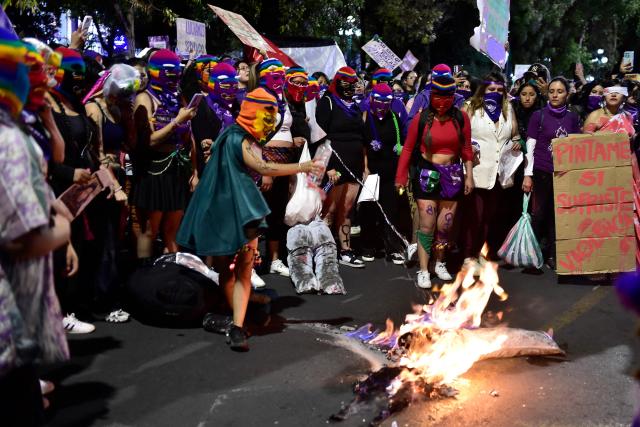 Feminist groups burn stuffed dolls during a march against government on the eve of International Women's Day in La Paz on March 6, 2026. The International Women's Rights Day will fall on March 8, 2026. (Photo by Jorge BERNAL / AFP)