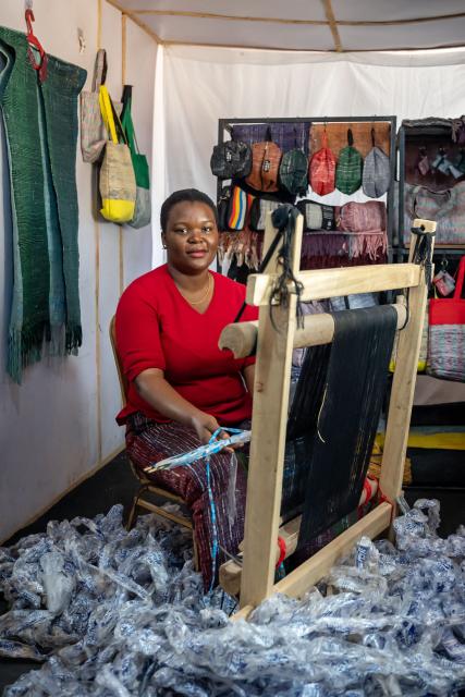 Rita Idehai, founder of Ecobarter, uses a loom to weave recycled water sachets into plabric in her office office in Abuja on March 4, 2026. Rita Idehai launched her company, Ecobarter, in Abuja in 2018, building on an idea she developed in 2017 to turn waste into resources.
She also created the Waste Resource Empowerment Program, which helps women in local communities turn plastic waste into handwoven materials used to produce bags, clothing, and other fashion items.
Through her work, plastics that would otherwise contribute to environmental pollution are repurposed and reintroduced into society as fashionable accessories. Ecobarter also encourages people to exchange recyclable waste for useful items, creating a system that rewards responsible waste disposal while helping reduce plastic pollution in local communities. (Photo by Light Oriye Tamunotonye / AFP)