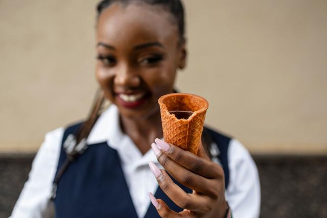 Kenyan innovator and ecopreneur, Sheryl Mboya, 26, poses with one of her innovations, an edible cup; an idea born of her dislike of plastic pollution in Nairobi on March 6, 2026. Christened 'snackuit', the law graduate's patented edible tableware is her answer to single-use plastics pollution and is alot safer for the general environment due to it's biodegradability.Developed under GreenX Telemechanics Limited, a technology and innovation developer whose core objective is to come up with innovative solutions such as Snackuit, that not only address challenges mankind face but also contribute to climate action. (Photo by Tony KARUMBA / AFP)