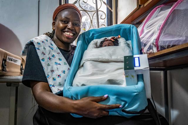 Vivian Arinaitwe, 24, a biomedical engineer and CEO of Che Innovations, displays a unit of NeoNest at their workspace in Kampala, on March 6, 2026. NeoNest is an award-winning, low-cost medical device developed by Che Innovations to prevent neonatal hypothermia during ambulance transfers from rural health facilities to referral hospitals. Designed for low-resource settings, the portable infant warmer helps maintain a stable temperature for preterm and low-birth-weight babies during transport, when they are most vulnerable to life-threatening heat loss. (Photo by Badru Katumba / AFP)