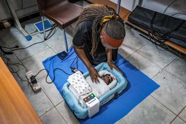 Vivian Arinaitwe, 24, a biomedical engineer and CEO of Che Innovations, displays a unit of NeoNest at their workspace in Kampala, on March 6, 2026. NeoNest is an award-winning, low-cost medical device developed by Che Innovations to prevent neonatal hypothermia during ambulance transfers from rural health facilities to referral hospitals. Designed for low-resource settings, the portable infant warmer helps maintain a stable temperature for preterm and low-birth-weight babies during transport, when they are most vulnerable to life-threatening heat loss. (Photo by Badru Katumba / AFP)