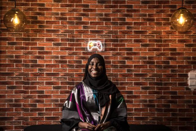 Game designer Mame Faty Kane poses for a portrait at the Game Hub in Dakar, on March 6, 2026. Mame Faty started playing video games at a young age. Instead of asking for dolls like her friends, she received a Game Boy from her parents. What began as a pastime slowly turned into a passion, and after finishing her studies, she began building her skills at Dakar’s Game Hub to become a game designer. To this day, she has created several video games, focusing mostly on educational ones like Cax Caxett (“find the riddle” in Wolof), where players can learn about Senegalese culture.“I can make my dreams come true when I create a video game. I’m always wondering, ‘Can I do this?’ and then I realize that there are no limits to what I can do as a game designer.” (Photo by PATRICK MEINHARDT / AFP)
