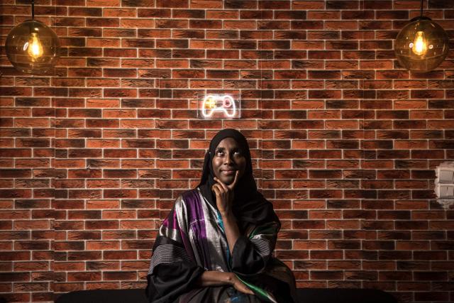 Game designer Mame Faty Kane poses for a portrait at the Game Hub in Dakar, on March 6, 2026. Mame Faty started playing video games at a young age. Instead of asking for dolls like her friends, she received a Game Boy from her parents. What began as a pastime slowly turned into a passion, and after finishing her studies, she began building her skills at Dakar’s Game Hub to become a game designer. To this day, she has created several video games, focusing mostly on educational ones like Cax Caxett (“find the riddle” in Wolof), where players can learn about Senegalese culture.“I can make my dreams come true when I create a video game. I’m always wondering, ‘Can I do this?’ and then I realize that there are no limits to what I can do as a game designer.” (Photo by PATRICK MEINHARDT / AFP)