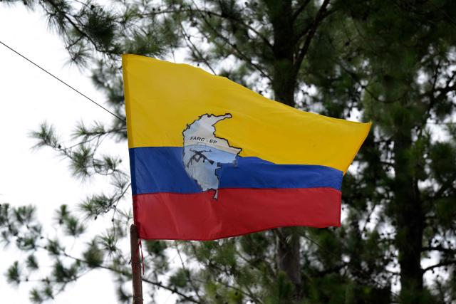 (FILES) A flag with the FARC EP logo flutter in the wind near the town of Suarez, department of Cauca, Colombia, on September 19, 2023, before a press conference to announce of start of peace talks between the Colombian Government and a dissident faction of the FARC guerrillas that calls itself the Central General Staff (EMC). On March 6, 2026, Ecuador bombed a training camp belonging to a dissident faction of the FARC guerrilla group operating on the border with Colombia, with support from the United States, President Daniel Noboa reported. (Photo by JOAQUIN SARMIENTO / AFP)