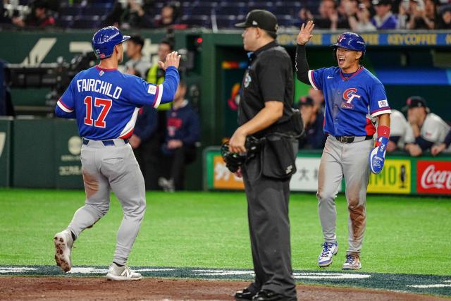 Taiwan's Tsung-Che Cheng (R) and Stuart Fairchild celebrate after scoring during the World Baseball Classic (WBC) Pool C game between Taiwan and Czech Republic at the Tokyo Dome in Tokyo on March 7, 2026. (Photo by Yuichi YAMAZAKI / AFP)