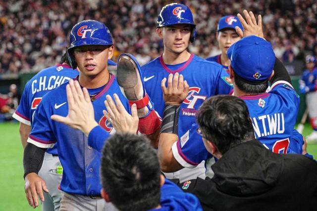 Taiwan's Tsung-Che Cheng (L) and Stuart Fairchild (2nd L) celebrate with teammates after scoring during the World Baseball Classic (WBC) Pool C game between Taiwan and Czech Republic at the Tokyo Dome in Tokyo on March 7, 2026. (Photo by Yuichi YAMAZAKI / AFP)