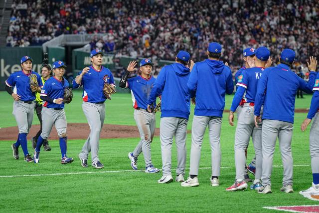 Taiwan players celebrate their victory after the World Baseball Classic (WBC) Pool C game between Taiwan and Czech Republic at the Tokyo Dome in Tokyo on March 7, 2026. (Photo by Yuichi YAMAZAKI / AFP)