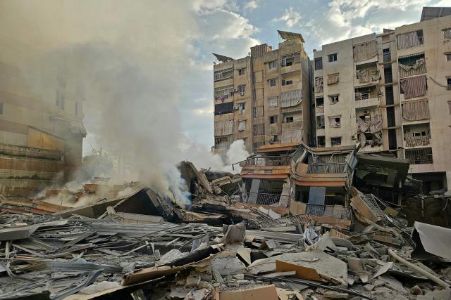 Smoke rises from the rubble of destroyed buildings at the site of an Israeli airstrike that targeted Haret Hreik neighbourhood in Beirut's southern suburbs, on March 7, 2026. Lebanese official media reported on March 7 that clashes had erupted as Israeli forces attempted a landing operation along the Lebanon-Syria border, with militant group Hezbollah saying its fighters were involved. There was no immediate comment from the Israeli military, which has launched numerous strikes and sent ground troops into Lebanon since Tehran-backed group Hezbollah fired missiles at Israel on March 2 to avenge the killing of Iranian supreme leader Ali Khamenei. (Photo by AFP)