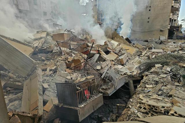 Smoke rises from the rubble of destroyed buildings at the site of an Israeli airstrike that targeted Haret Hreik neighbourhood in Beirut's southern suburbs, on March 7, 2026. Lebanese official media reported on March 7 that clashes had erupted as Israeli forces attempted a landing operation along the Lebanon-Syria border, with militant group Hezbollah saying its fighters were involved. There was no immediate comment from the Israeli military, which has launched numerous strikes and sent ground troops into Lebanon since Tehran-backed group Hezbollah fired missiles at Israel on March 2 to avenge the killing of Iranian supreme leader Ali Khamenei. (Photo by AFP)
