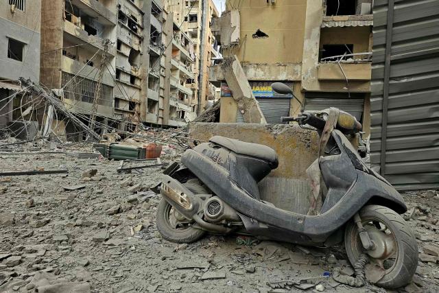 A damaged scooter stands amid the debris of destroyed buildings at the site of an Israeli airstrike that targeted Haret Hreik neighbourhood in Beirut's southern suburbs, on March 7, 2026. Lebanese official media reported on March 7 that clashes had erupted as Israeli forces attempted a landing operation along the Lebanon-Syria border, with militant group Hezbollah saying its fighters were involved. There was no immediate comment from the Israeli military, which has launched numerous strikes and sent ground troops into Lebanon since Tehran-backed group Hezbollah fired missiles at Israel on March 2 to avenge the killing of Iranian supreme leader Ali Khamenei. (Photo by AFP)