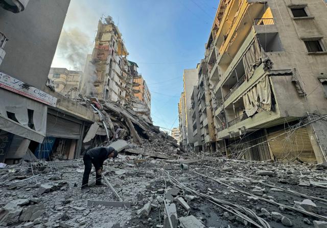 A man inspects the debris of destroyed buildings at the site of an Israeli airstrike that targeted Haret Hreik neighbourhood in Beirut's southern suburbs, on March 7, 2026. Lebanese official media reported on March 7 that clashes had erupted as Israeli forces attempted a landing operation along the Lebanon-Syria border, with militant group Hezbollah saying its fighters were involved. There was no immediate comment from the Israeli military, which has launched numerous strikes and sent ground troops into Lebanon since Tehran-backed group Hezbollah fired missiles at Israel on March 2 to avenge the killing of Iranian supreme leader Ali Khamenei. (Photo by AFP)