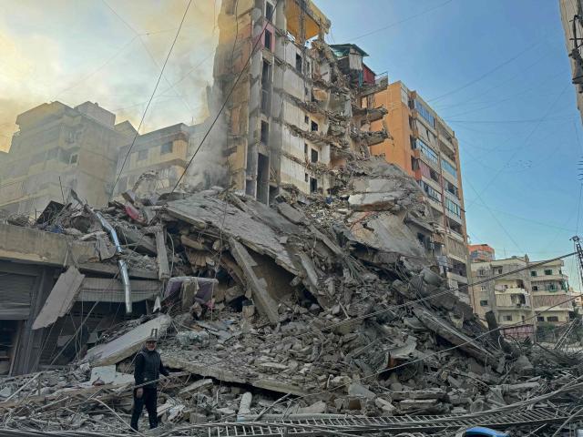 A man inspects the debris of destroyed buildings at the site of an Israeli airstrike that targeted Haret Hreik neighbourhood in Beirut's southern suburbs, on March 7, 2026. Lebanese official media reported on March 7 that clashes had erupted as Israeli forces attempted a landing operation along the Lebanon-Syria border, with militant group Hezbollah saying its fighters were involved. There was no immediate comment from the Israeli military, which has launched numerous strikes and sent ground troops into Lebanon since Tehran-backed group Hezbollah fired missiles at Israel on March 2 to avenge the killing of Iranian supreme leader Ali Khamenei. (Photo by AFP)