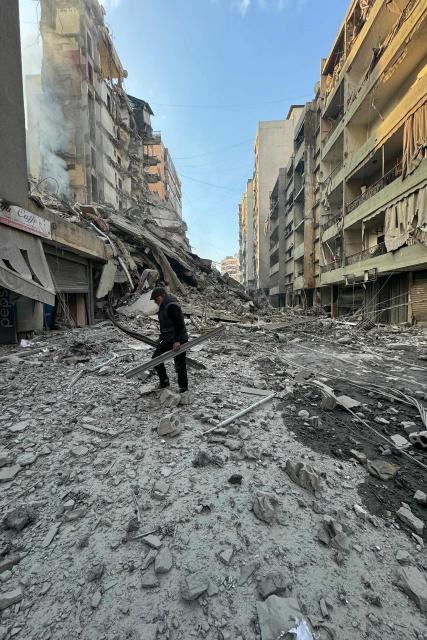 A man inspects the debris of destroyed buildings at the site of an Israeli airstrike that targeted Haret Hreik neighbourhood in Beirut's southern suburbs, on March 7, 2026. Lebanese official media reported on March 7 that clashes had erupted as Israeli forces attempted a landing operation along the Lebanon-Syria border, with militant group Hezbollah saying its fighters were involved. There was no immediate comment from the Israeli military, which has launched numerous strikes and sent ground troops into Lebanon since Tehran-backed group Hezbollah fired missiles at Israel on March 2 to avenge the killing of Iranian supreme leader Ali Khamenei. (Photo by AFP)