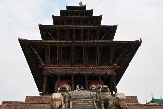 Children visit a temple at Durbar Square in Bhaktapur near Kathmandu on March 7, 2026. Nepal's centrist party of rapper-turned-politician Balendra Shah looked set to win by a landslide in parliamentary polls, according to Election Commission trends March 7, but with counting still far to go. (Photo by Tauseef MUSTAFA / AFP)