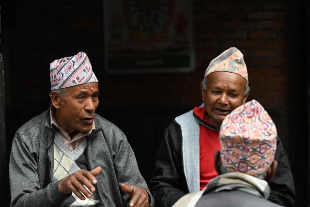 People speak with each other at Durbar Square in Bhaktapur near Kathmandu on March 7, 2026. Nepal's centrist party of rapper-turned-politician Balendra Shah looked set to win by a landslide in parliamentary polls, according to Election Commission trends March 7, but with counting still far to go. (Photo by Tauseef MUSTAFA / AFP)
