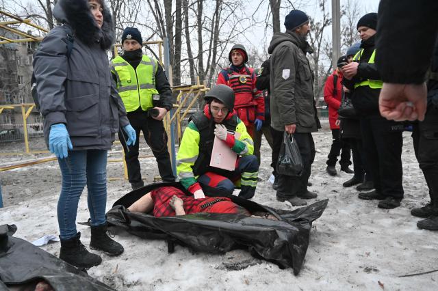 EDITORS NOTE: Graphic content / TOPSHOT - Police experts examine a body retrieved from under the rubbles of a five-story residential building which was hit by a ballistic missile in Kharkiv on March 7, 2026 amid the Russian invasion of Ukraine. Russia pummelled Ukraine with drone and missile attacks overnight, killing six people and triggering air alerts across the country, officials said. The bodies of five people were found in the rubble of an apartment block in the eastern Kharkiv region, while one person was killed in the Dnipropetrovsk region. (Photo by SERGEY BOBOK / AFP)