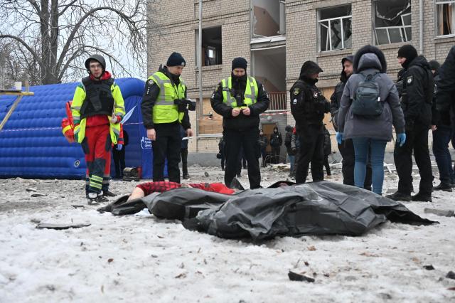EDITORS NOTE: Graphic content / Police experts examine a body retrieved from under the rubbles of a five-story residential building which was hit by a ballistic missile in Kharkiv on March 7, 2026 amid the Russian invasion of Ukraine. Russia pummelled Ukraine with drone and missile attacks overnight, killing six people and triggering air alerts across the country, officials said. The bodies of five people were found in the rubble of an apartment block in the eastern Kharkiv region, while one person was killed in the Dnipropetrovsk region. (Photo by SERGEY BOBOK / AFP)