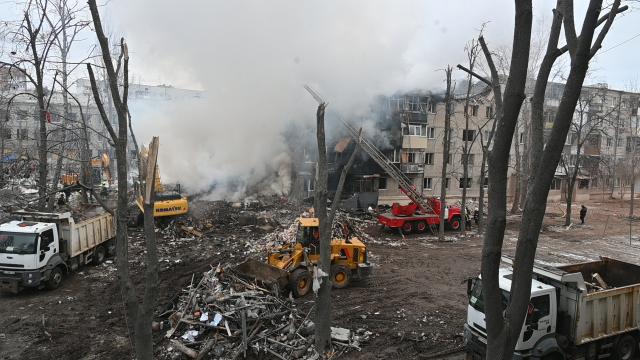 Rescuers work at the bottom of a five-story residential building which was hit by a ballistic missile in Kharkiv on March 7, 2026 amid the Russian invasion of Ukraine. Russia pummelled Ukraine with drone and missile attacks overnight, killing six people and triggering air alerts across the country, officials said. The bodies of five people were found in the rubble of an apartment block in the eastern Kharkiv region, while one person was killed in the Dnipropetrovsk region. (Photo by SERGEY BOBOK / AFP)