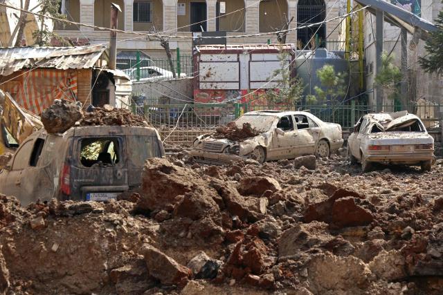 This photograph taken during a media tour organised by the Hezbollah shows damaged cars at Nabi Sheet town after an Israeli military operation in the Bekaa Valley of Lebanon, on March 7, 2026. Hezbollah on March 7 said it confronted Israeli troops that infiltrated an east Lebanon town overnight, with Lebanese authorities reporting at least 16 killed in Israeli strikes on the area. (Photo by Nidal SOLH / AFP)
