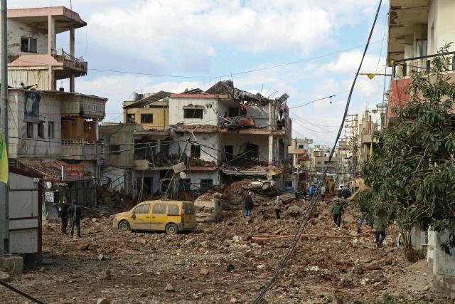 This photograph taken during a media tour organised by the Hezbollah shows people inspecting the destruction at Nabi Sheet town after an Israeli military operation in the Bekaa Valley of Lebanon, on March 7, 2026. Hezbollah on March 7 said it confronted Israeli troops that infiltrated an east Lebanon town overnight, with Lebanese authorities reporting at least 16 killed in Israeli strikes on the area. (Photo by Nidal SOLH / AFP)