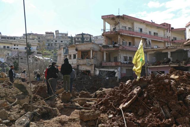 This photograph taken during a media tour organised by the Hezbollah shows people inspecting the destruction at Nabi Sheet town after an Israeli military operation in the Bekaa Valley of Lebanon, on March 7, 2026. Hezbollah on March 7 said it confronted Israeli troops that infiltrated an east Lebanon town overnight, with Lebanese authorities reporting at least 16 killed in Israeli strikes on the area. (Photo by Nidal SOLH / AFP)