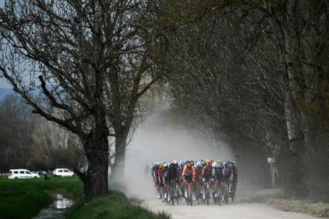 The pack rides during the 20th one-day classic 'Strade Bianche' (White Roads) men's cycling race between Siena and Siena in Tuscany on March 7, 2026. (Photo by Marco BERTORELLO / AFP)