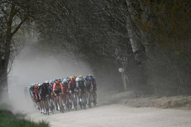 The pack rides during the 20th one-day classic 'Strade Bianche' (White Roads) men's cycling race between Siena and Siena in Tuscany on March 7, 2026. (Photo by Marco BERTORELLO / AFP)