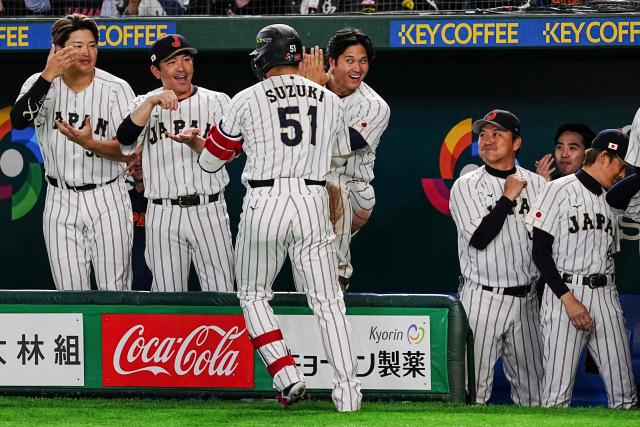 Japan's Seiya Suzuki (center L) celebrates with Shohei Ohtani (center R) after hitting a home run during the World Baseball Classic (WBC) Pool C game between Japan and South Korea at the Tokyo Dome in Tokyo on March 7, 2026. (Photo by Yuichi YAMAZAKI / AFP)
