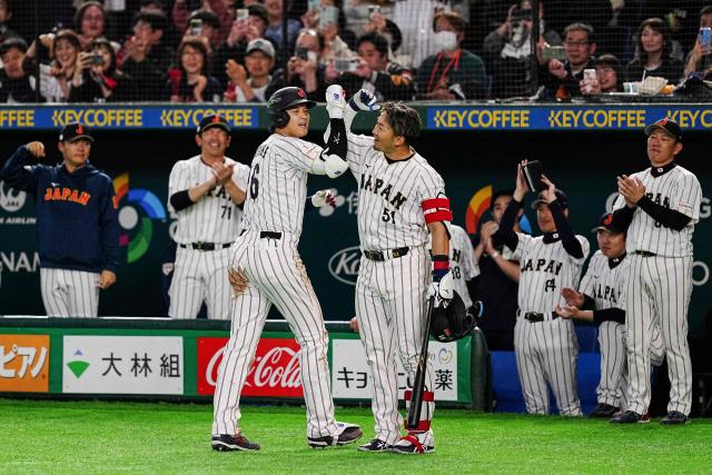 Japan's Shohei Ohtani (center L) celebrates with Japan's Seiya Suzuki (center R) after hitting a home run during the World Baseball Classic (WBC) Pool C game between Japan and South Korea at the Tokyo Dome in Tokyo on March 7, 2026. (Photo by Yuichi YAMAZAKI / AFP)