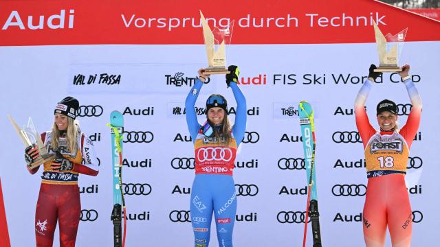 (LtoR) Second placed Austria's Cornelia Hutter, winner Italy's Laura Pirovano and third placed Switzerland's Corinne Suter celebrate on the podium after the Women's Downhill race of the FIS Ski World Cup at the La Volata slope in the Passo San Pellegrino ski area, Val di Fassa, Italy on March 7, 2026. (Photo by Andreas SOLARO / AFP)