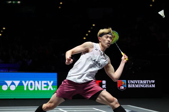Taiwan's Lin Chun-yi returns against Thailand's Kunlavut Vitidsarn during their men's singles semi-final at the All England Open Badminton Championships at the Utilita Arena in Birmingham, central England, on March 7, 2026. (Photo by Darren Staples / AFP)