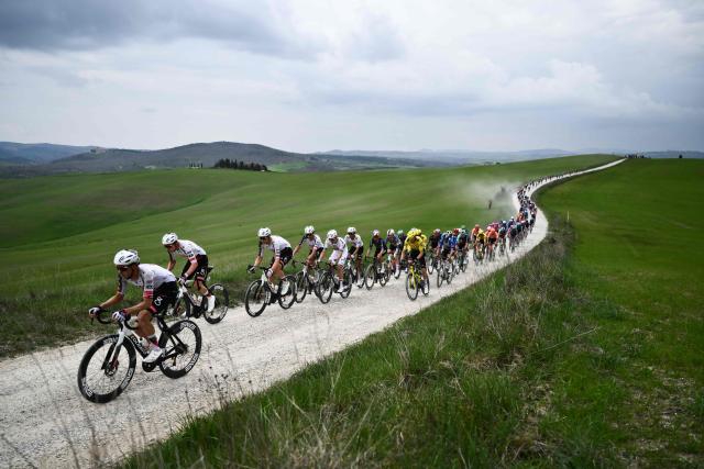 The pack rides during the 20th one-day classic 'Strade Bianche' (White Roads) men's cycling race between Siena and Siena in Tuscany on March 7, 2026. (Photo by Marco BERTORELLO / AFP)
