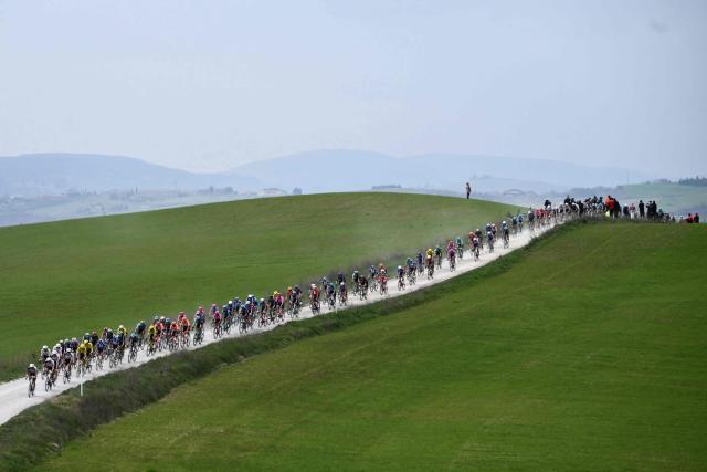 The pack rides during the 20th one-day classic 'Strade Bianche' (White Roads) men's cycling race between Siena and Siena in Tuscany on March 7, 2026. (Photo by Marco BERTORELLO / AFP)