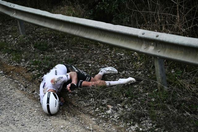 NSN Cycling Team's New Zealander George Bennett lies on the ground after a crash during the 20th one-day classic 'Strade Bianche' (White Roads) men's cycling race between Siena and Siena in Tuscany on March 7, 2026. (Photo by Marco BERTORELLO / AFP)