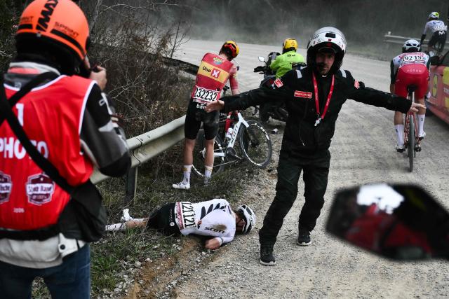 NSN Cycling Team's New Zealander George Bennett lies on the ground after a crash during the 20th one-day classic 'Strade Bianche' (White Roads) men's cycling race between Siena and Siena in Tuscany on March 7, 2026. (Photo by Marco BERTORELLO / AFP)