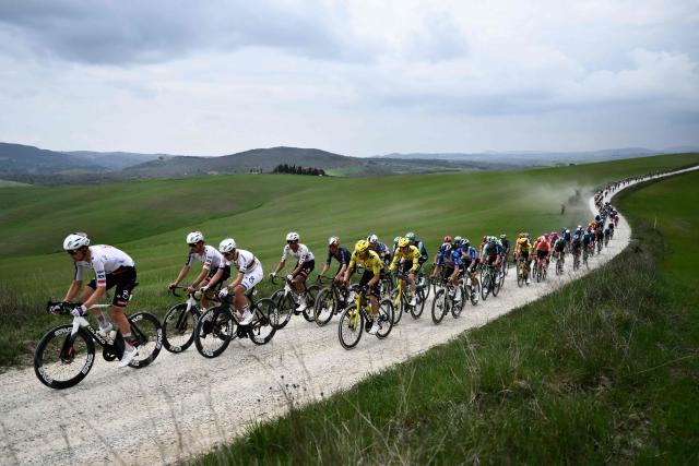 The pack rides during the 20th one-day classic 'Strade Bianche' (White Roads) men's cycling race between Siena and Siena in Tuscany on March 7, 2026. (Photo by Marco BERTORELLO / AFP)