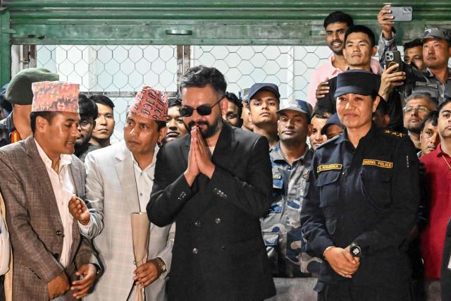 Rastriya Swatantra Party (RSP) election candidate Balendra Shah (C) greets supporters after collecting a certificate for his victory in parliamentary elections at the counting centre in Damak in Nepal's Jhapa district on March 7, 2026. Nepal's rapper-turned-mayor Shah grinned and flashed a V for victory sign on March 7 as Election Commission officials confirmed he had defeated veteran leader KP Sharma Oli in their parliamentary constituency. (Photo by Prakash MATHEMA / AFP)