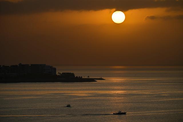 The sun rises over Panama Bay in Panama City on March 7, 2026. (Photo by MARTIN BERNETTI / AFP)