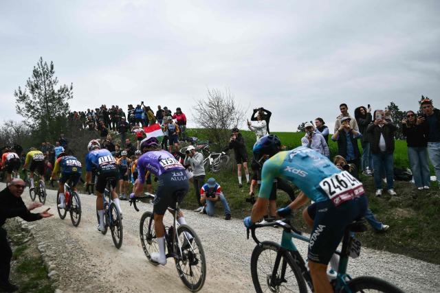 Supporters cheer the breakaway during the 20th one-day classic 'Strade Bianche' (White Roads) men's cycling race between Siena and Siena in Tuscany on March 7, 2026. (Photo by Marco BERTORELLO / AFP)