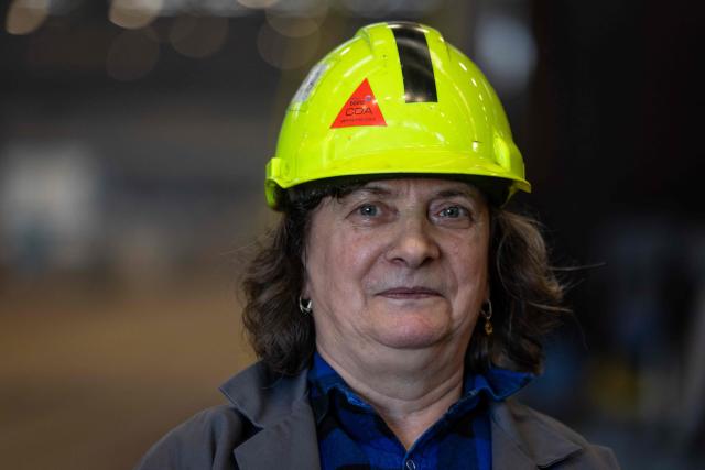 Halina Krauze, 65, a overhead crane operator, poses for a photo in the production hall of the Gdansk Shipyard in Gdansk, Poland, on March 6, 2026. "Around 70% of crane operators on construction sites today are women," Krause explains, a tradition inherited from the communist era. The shipyard, known as the birthplace of the Solidarnosc trade union that led to the fall of communism in Poland in 1989, still builds some ships but today, mainly wind turbines are produced at the site. (Photo by Wojtek RADWANSKI / AFP)